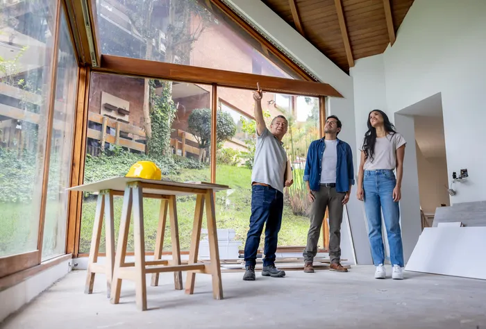 Free in-home renovation consultation with Leo Constra contractor and homeowners reviewing plans in bright modern home in Toronto