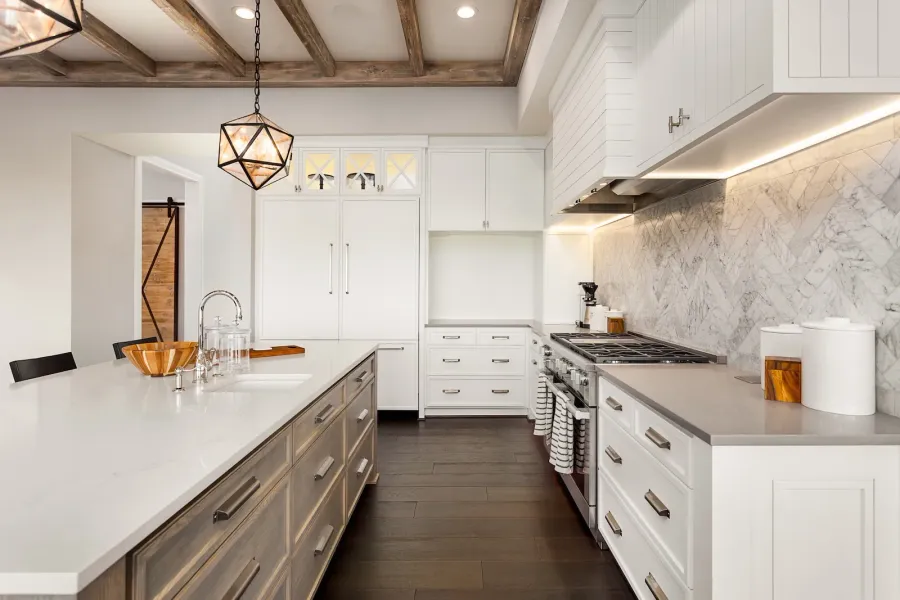 Custom luxury kitchen renovation with white shaker cabinets, waterfall marble backsplash, exposed wood beams, and large island in Toronto home