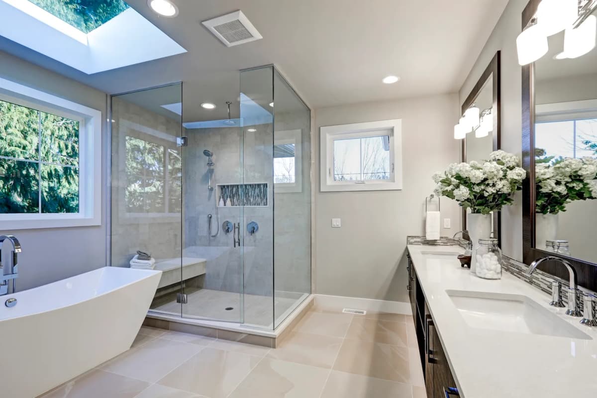 Luxury spa-inspired bathroom renovation with freestanding soaking tub, glass shower enclosure, and contemporary vanity in Toronto
